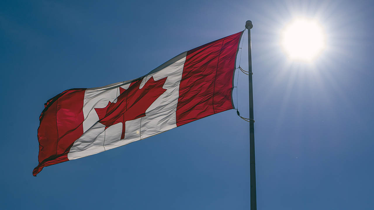 A Canadian flag flying on a pole