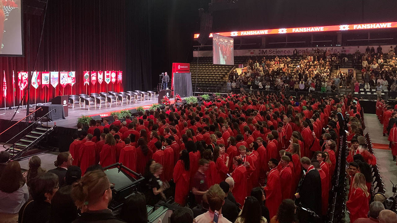 Fanshawe graduates standing on the floor of Budweiser Gardens.