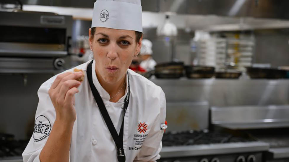 Chef Erin Circelli-Russell tasting some food.