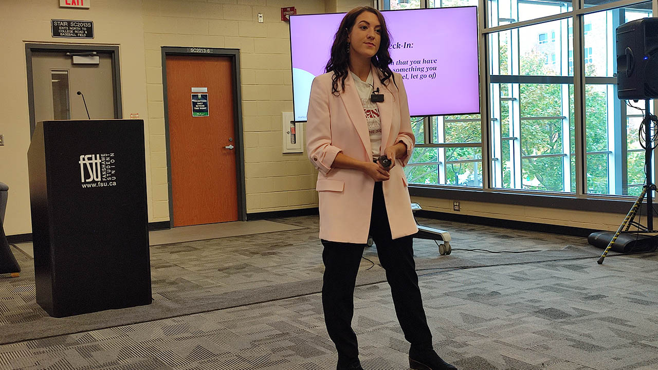 Marlee Liss standing while giving a presentation at Fanshawe College.
