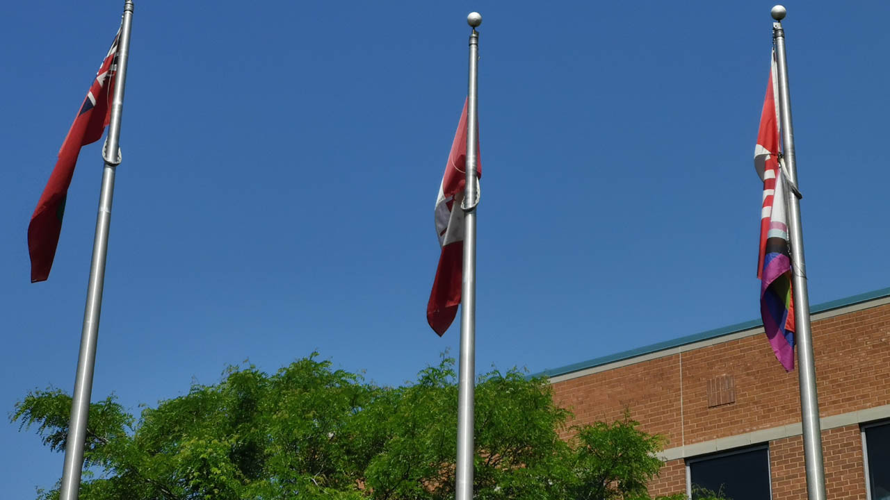 Flags flying outside Fanshawe College.