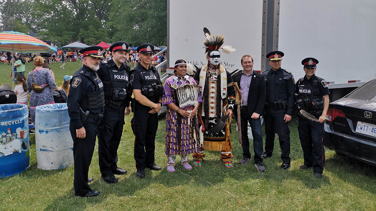 Eight people posing for a photo at a National Indigenous Peoples day event.