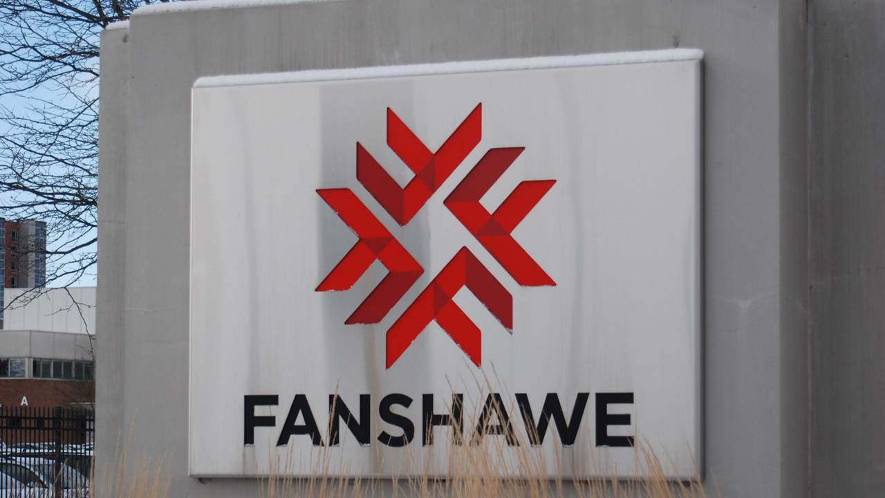 An outdoor sign with the Fanshawe College logo.