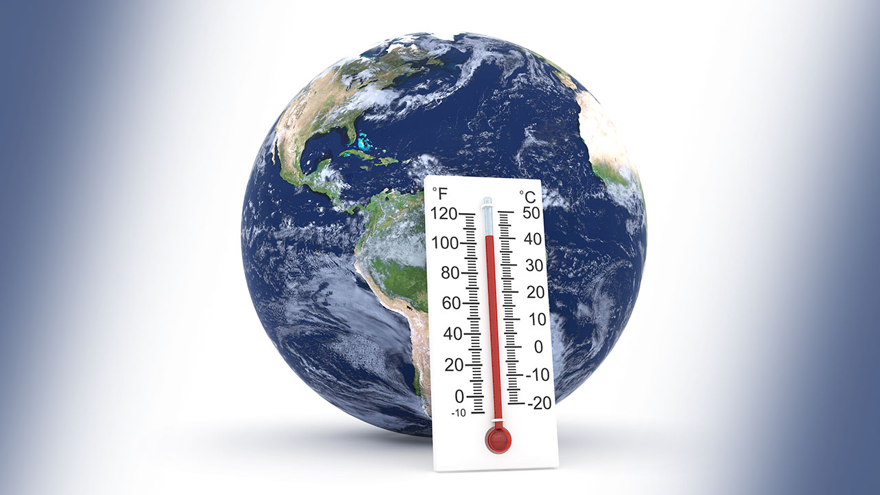 Stock image of planet Earth with a rising thermometer overlaid