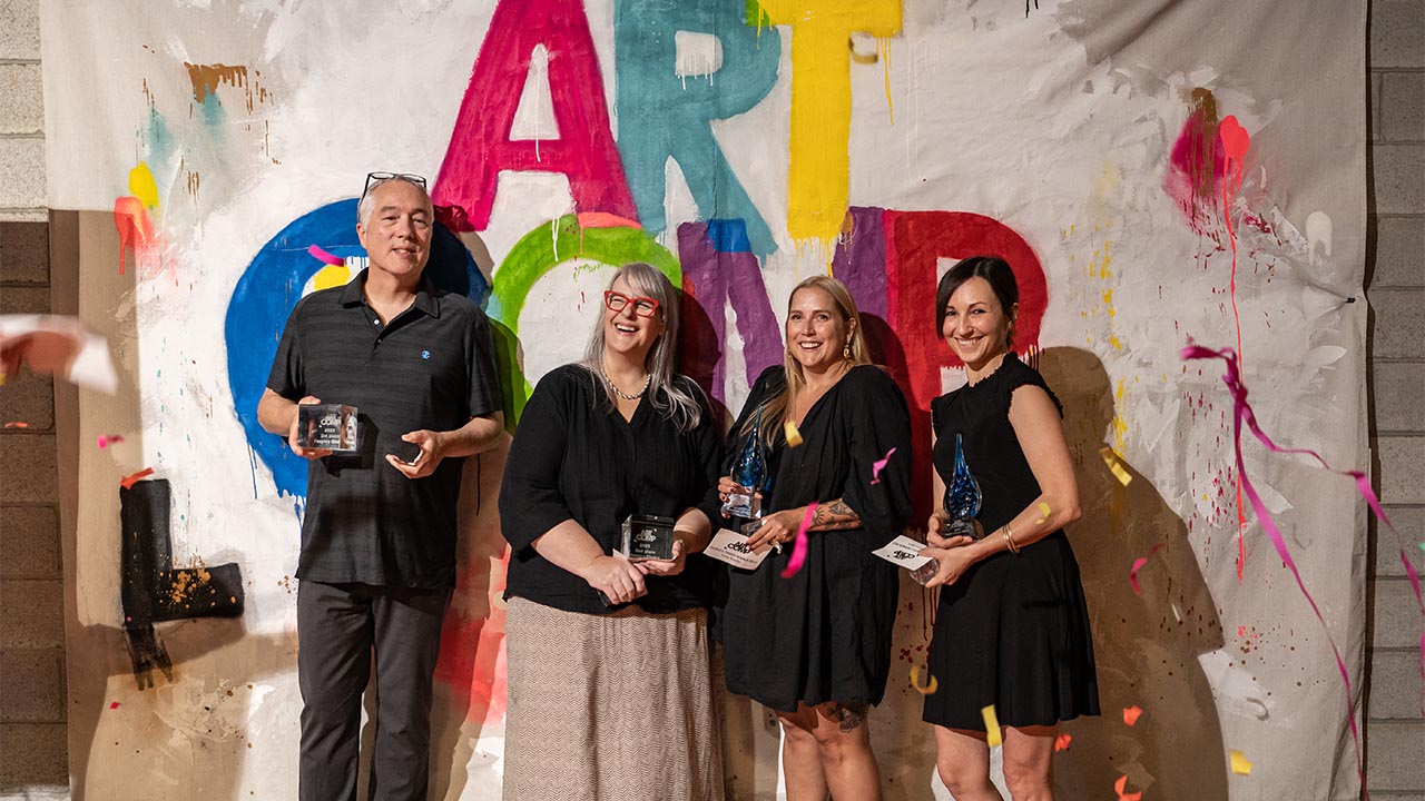 A photo of the previous Art Comp winners holding their trophies