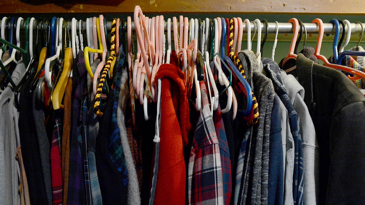 A closet full of various clothing items.