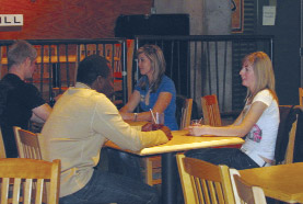 Potential matches try to make a love connection during an evening of speed dating at the Out Back Shack. The event attracted 18 female and 18 male participants.