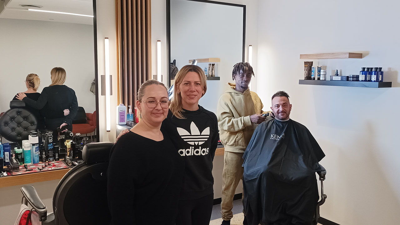 A photo of the co-owners of Dernier CRI Hair Group, Deborah Evans ,and Kamar Baroudi, alongside manager Alexandra Perek and barber Josh FK, posing in the salon.