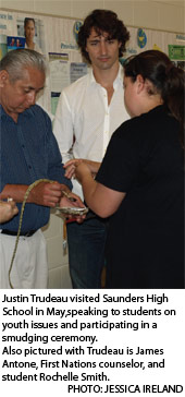 Justin Trudeau visited Saunders High
School in May,speaking to students on
youth issues and participating in a
smudging ceremony.
Also pictured with Trudeau is James
Antone, First Nations counselor, and
student Rochelle Smith.