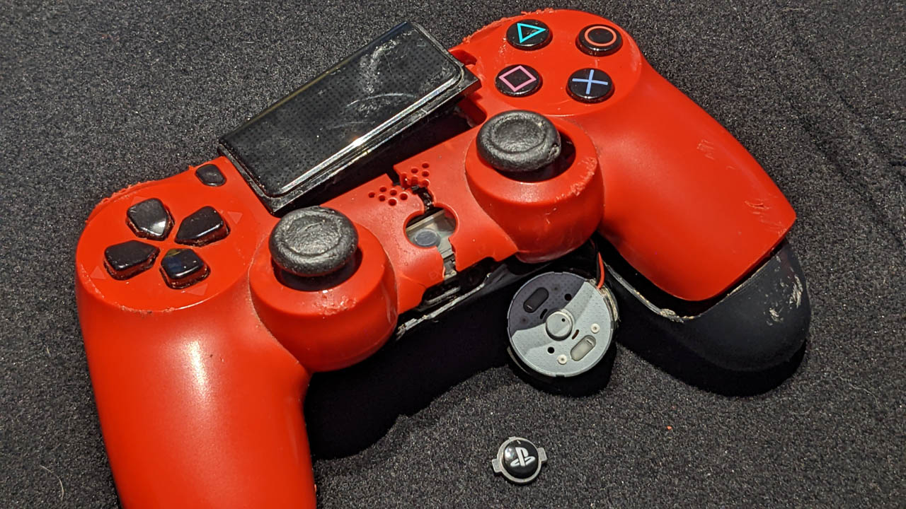 A broken, red, PS video game controller.