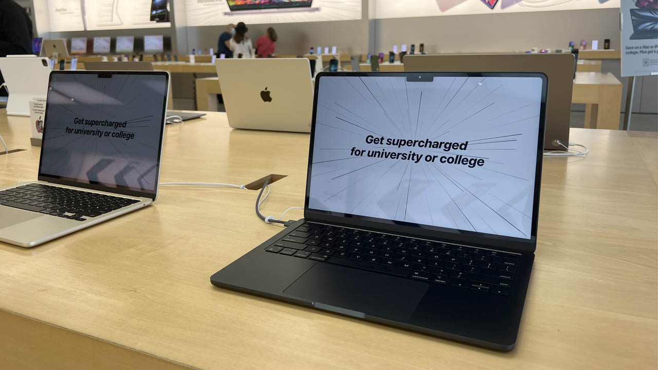 Two laptops with the text, Get supercharged for university or college displayed on their screens.