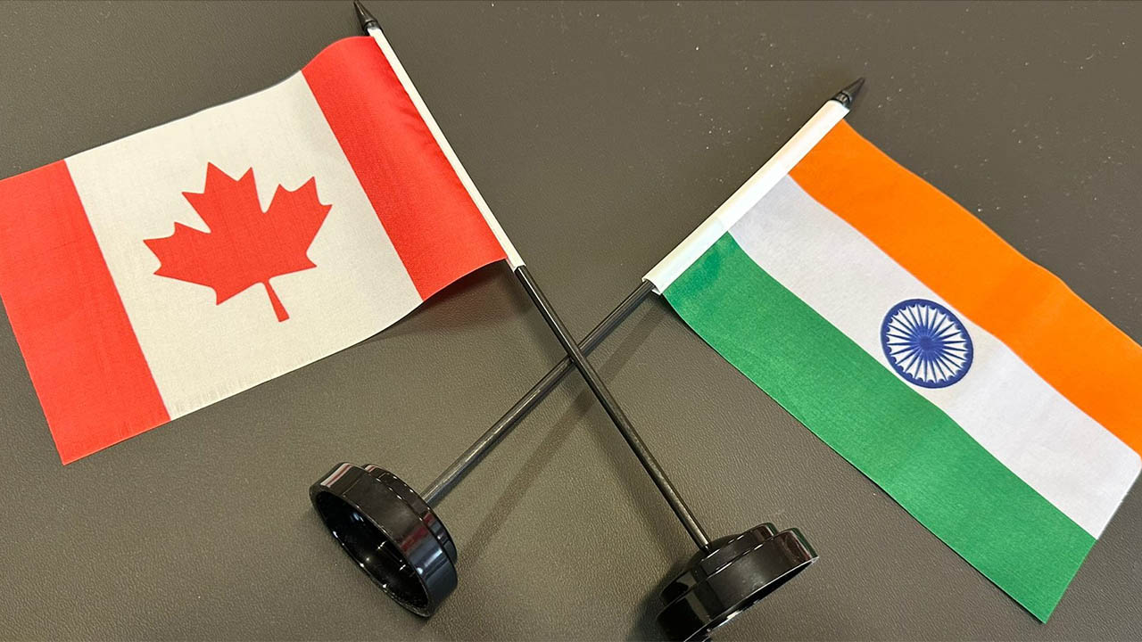 A photo of the flag of India and the flag of Canada side by side