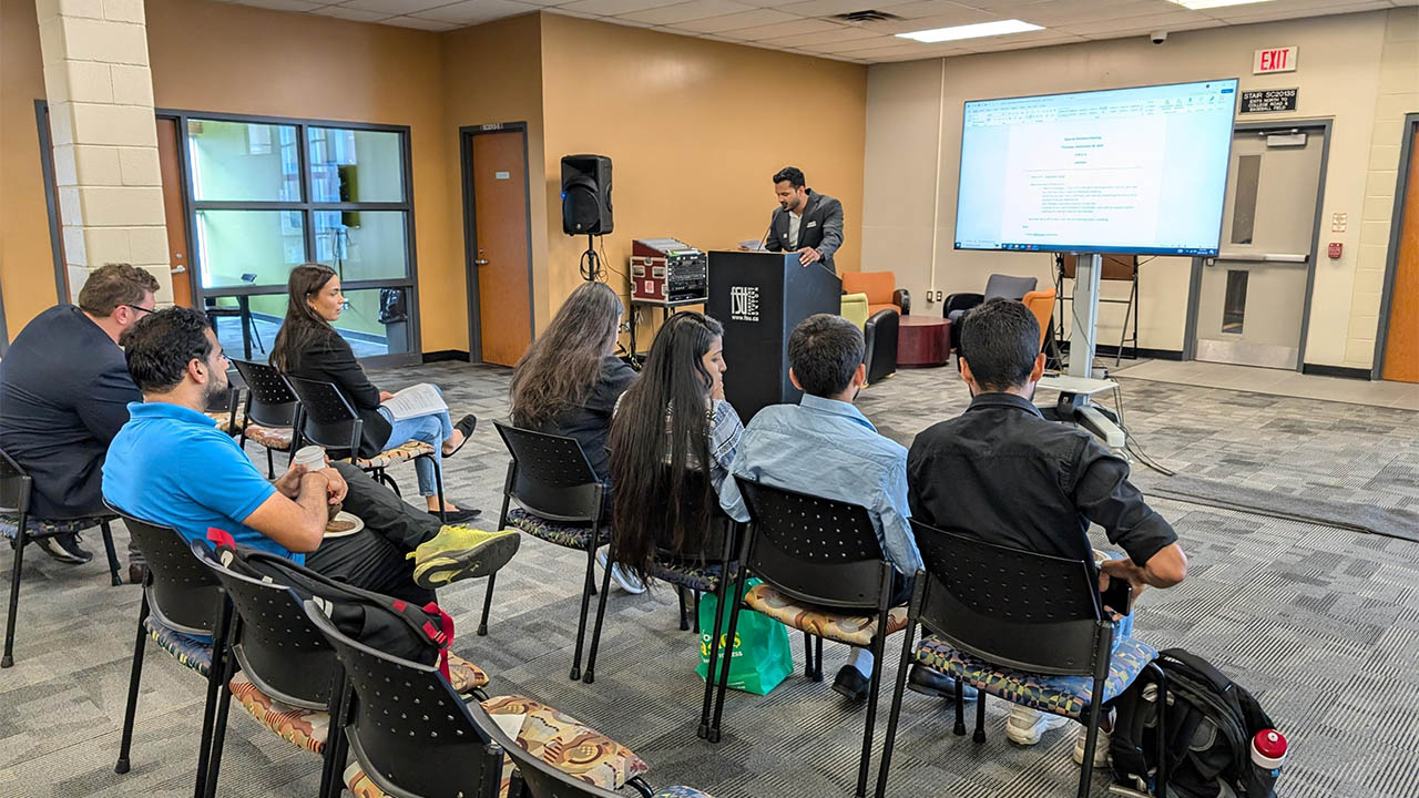 A photo of FSU President Siddharth Singh presenting an update at the FSU Special Members Meeting. 
