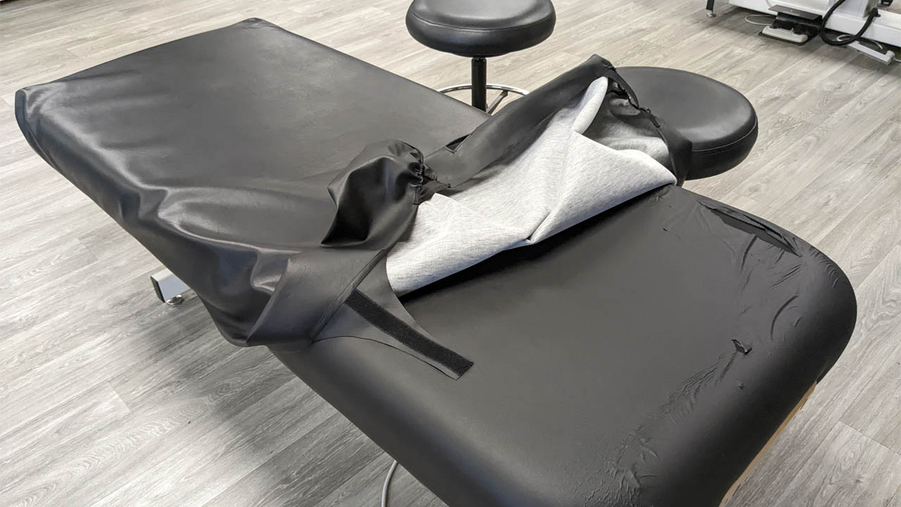 A photo showing the massage therapy tables with new covers.