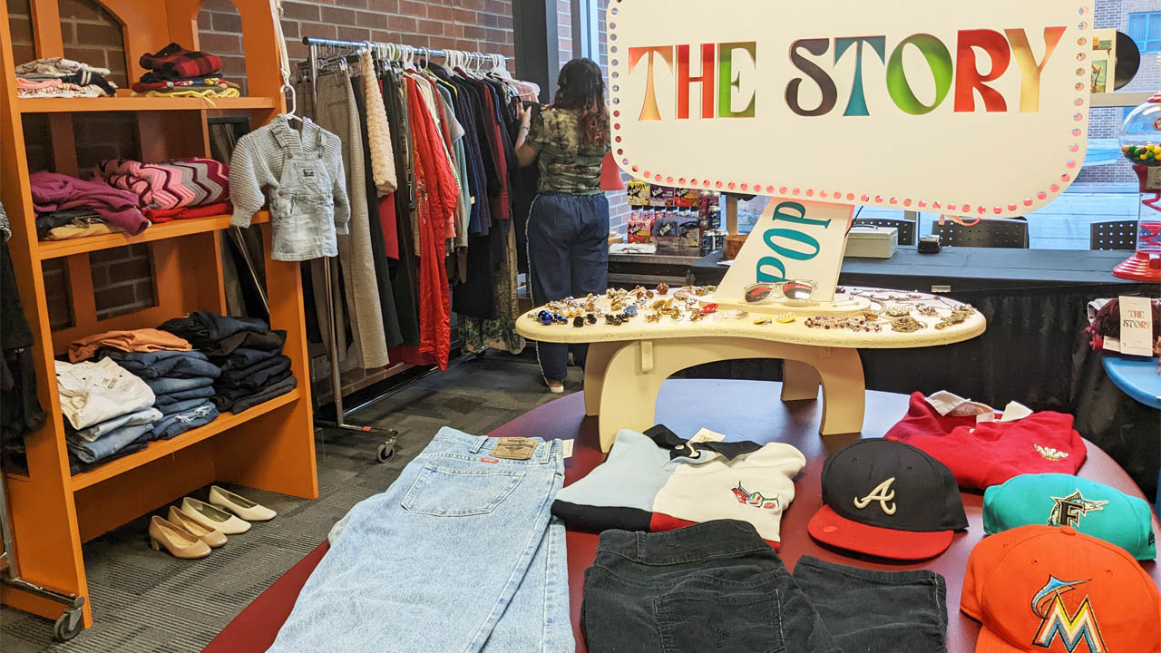 Photo of The Story pop-up shop, featuring the store logo and clothing display.