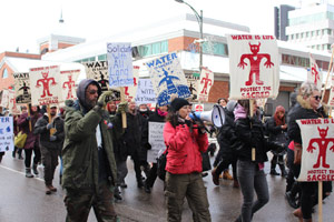 "Our world is falling apart": Local protesters march against pipeline, RCMP photos