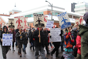 "Our world is falling apart": Local protesters march against pipeline, RCMP photos